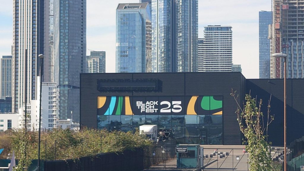 A shot of the Black Tech Fest marquee from a distance with the London skyline behind it.