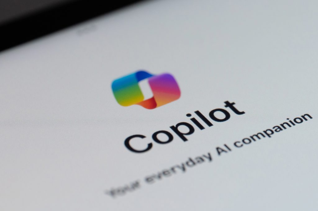 Logo of Microsoft Copilot app on a mobile device screen, showing the colorful Copilot icon above the word “Copilot” and the tagline “Your everyday AI companion” on a white background.