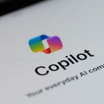 Logo of Microsoft Copilot app on a mobile device screen, showing the colorful Copilot icon above the word “Copilot” and the tagline “Your everyday AI companion” on a white background.