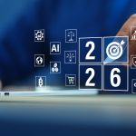 Person using a laptop with a blue background, surrounded by floating digital icons showing “2026” and symbols for AI, finance, sustainability, shopping cart, target, blockchain, and other business and technology goals.